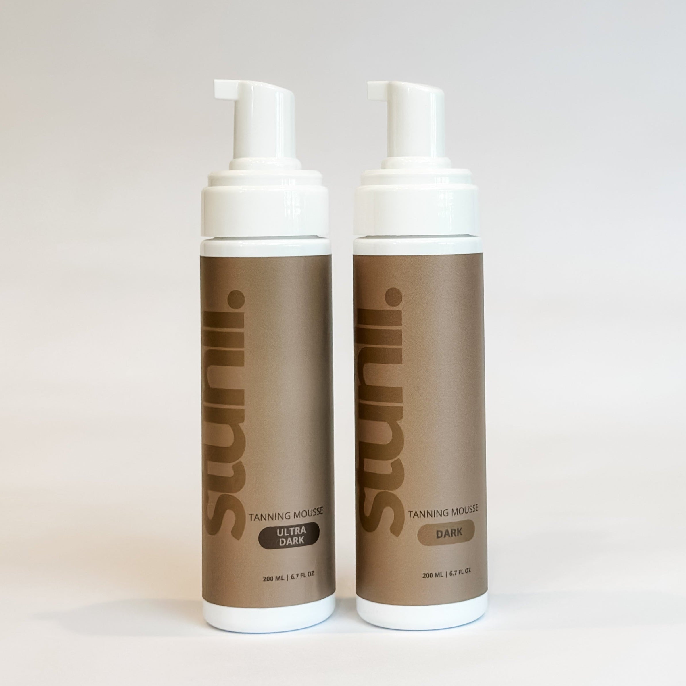 Two bottles of Stunli tanning mousse on a white background