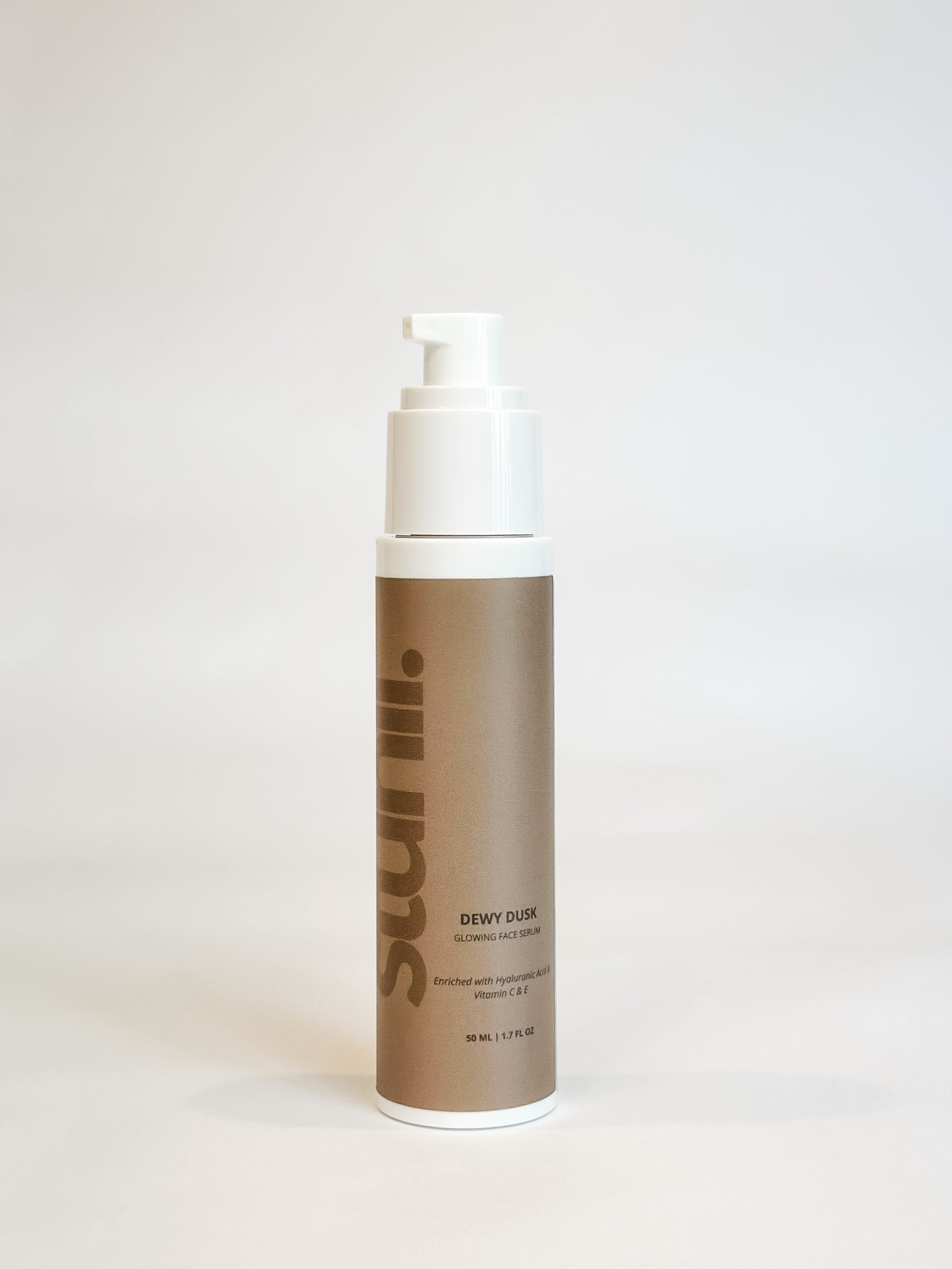A bottle of Dewy Dusk Serum with a pump dispenser, labeled with the product name and brand.