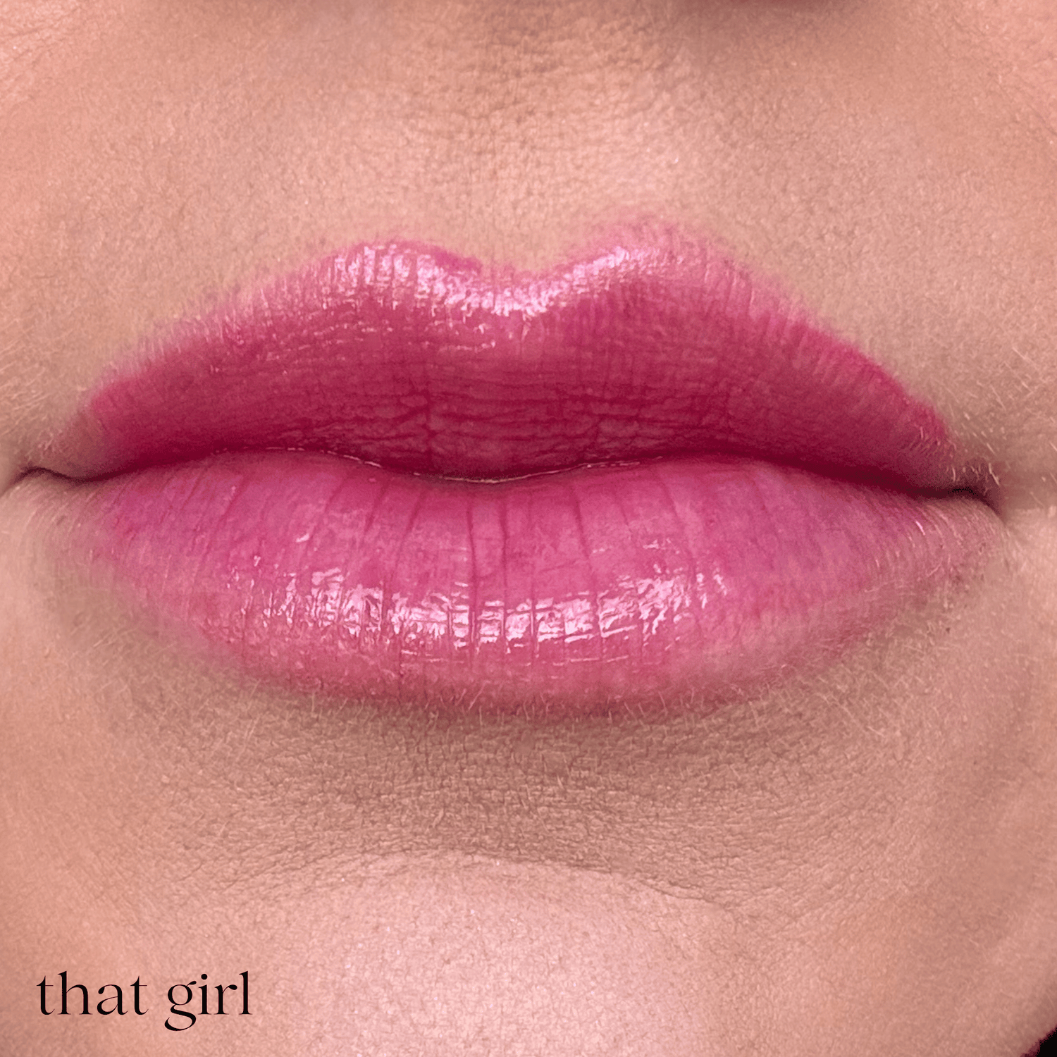 Close-up of glossy pink lips with the text &