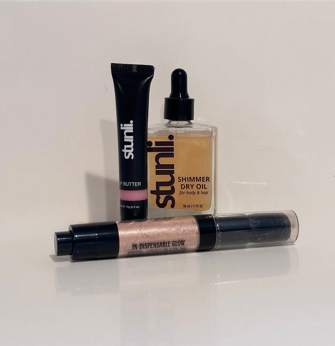 Three Stunli beauty products on a white surface